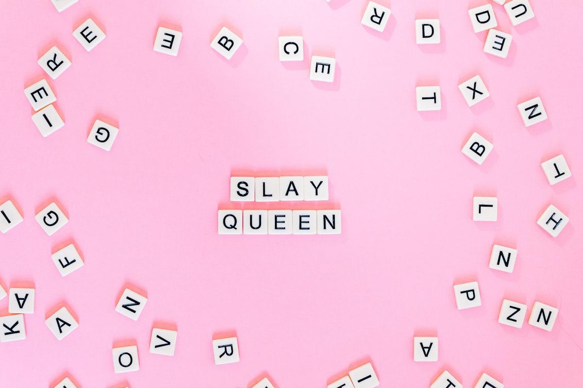 Scrabble pieces on pink surface related to A Comprehensive Guide to Queen Size Beds: How Big Are They Really?