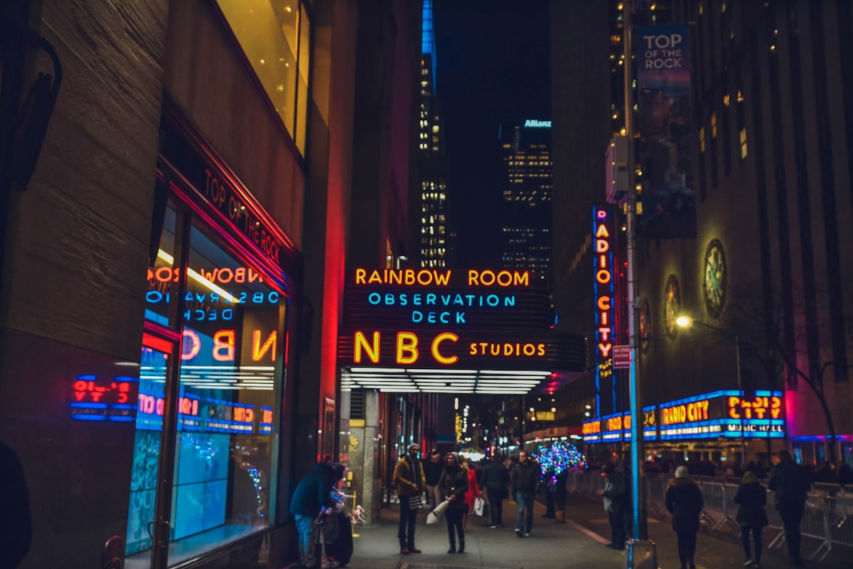 several people walking beside NBC Studios building related to Experience Ultimate Comfort at Movie Theaters with Beds in NYC