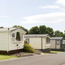 Several static caravans are parked along a road. related to Luxurious Comfort: Discovering Waterford Bedding Collections
