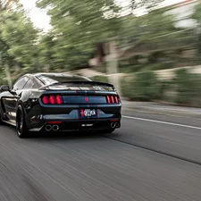 Shelby Mustang driving down the street. related to 2010 Mustang Rear Valance