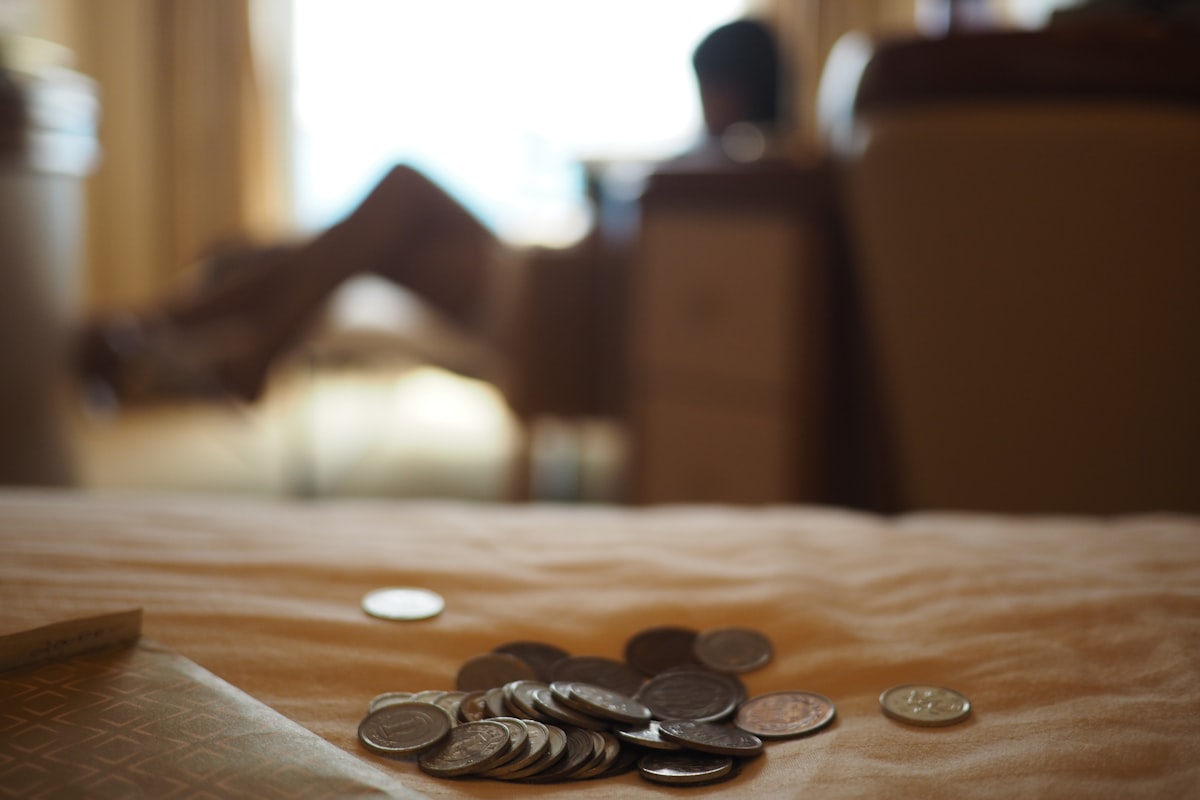silver coins on brown wooden table related to Maximizing Savings: Unlocking the Best Bed Bath & Beyond 20 Coupon Deals