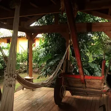 Small hut for coffee plantation workers to rest, with hammocks and an oxcart for carrying coffee. In the background, the plantation owners house. Conserved house of the 19th century  related to The Ultimate Relaxation Spot: Hanging Porch Beds 101