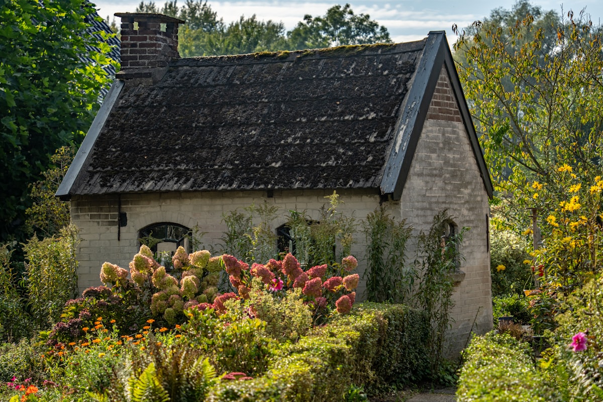 Small stone cottage surrounded by lush garden related to A Charming Escape: Garden House Bed & Breakfast in Key West, FL