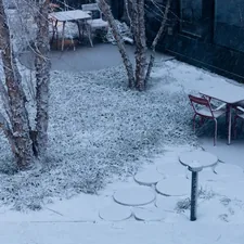 Snow covers an outdoor seating area with tables and chairs. related to Warming Your Outdoor Space with a Delightful Twist: Fish Shaped Chiminea