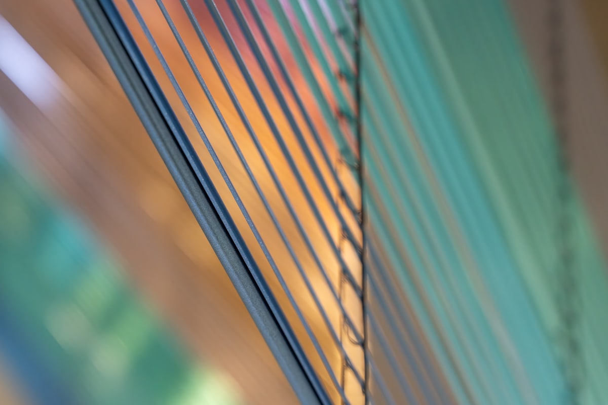 Stack of tinted glass panes with reflections related to Revealing the Anatomy of Vertical Blind Valance Parts