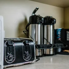 stainless steel bread toaster on brown wooden table related to Sizzling Deals: Navigating Bed Bath and Beyond Toasters