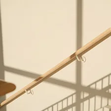 Staircase with railing casting shadows on the wall. related to Introducing the Ultimate Bed Rail Hooks