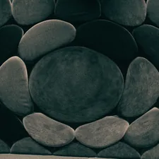 Stone-like cushions form a patterned wall. related to Round Bed for Sale: A Perfect Addition to Your Home