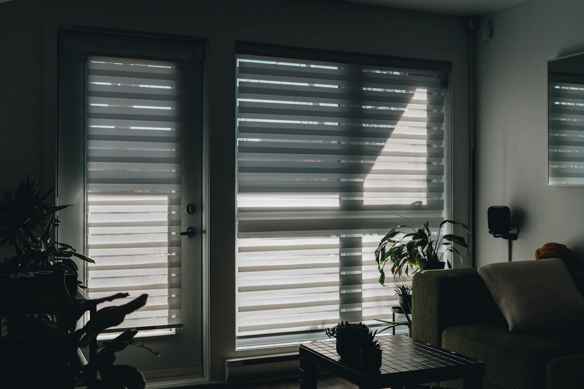 Sunlight shines through a window with blinds. related to Zebra Valance Curtains: A Stylish Twist to Window Decor