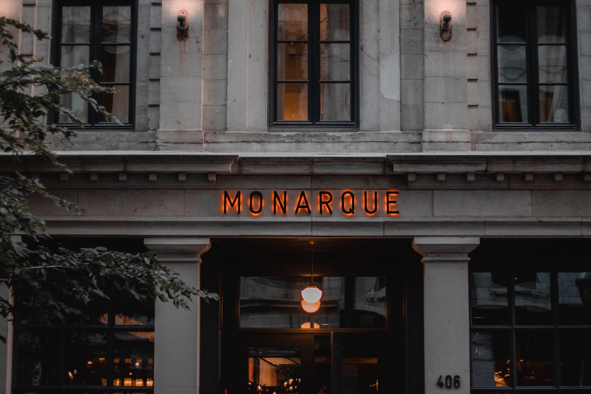 the front of a building with a neon sign on it related to Discovering the Charm of Montreal Bed and Breakfasts