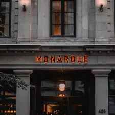the front of a building with a neon sign on it related to Discovering the Charm of Montreal Bed and Breakfasts