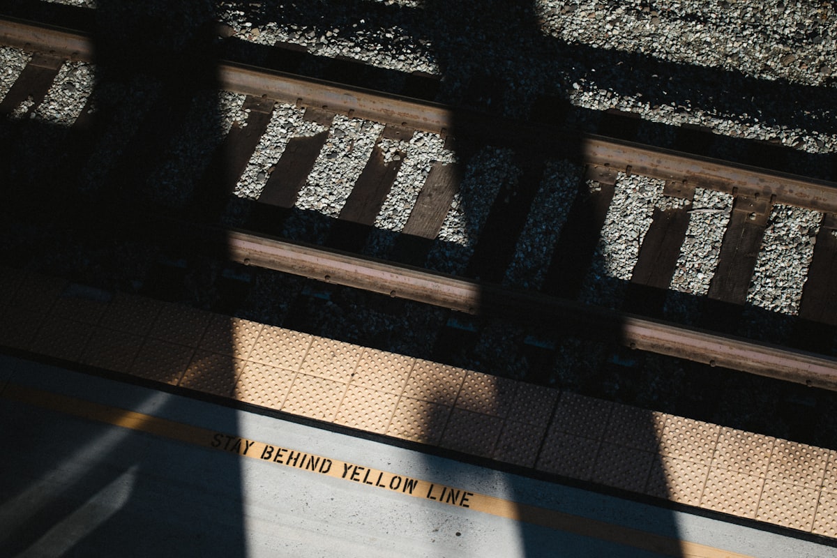 the shadow of a person standing on a train platform related to Yellow Gray Valance
