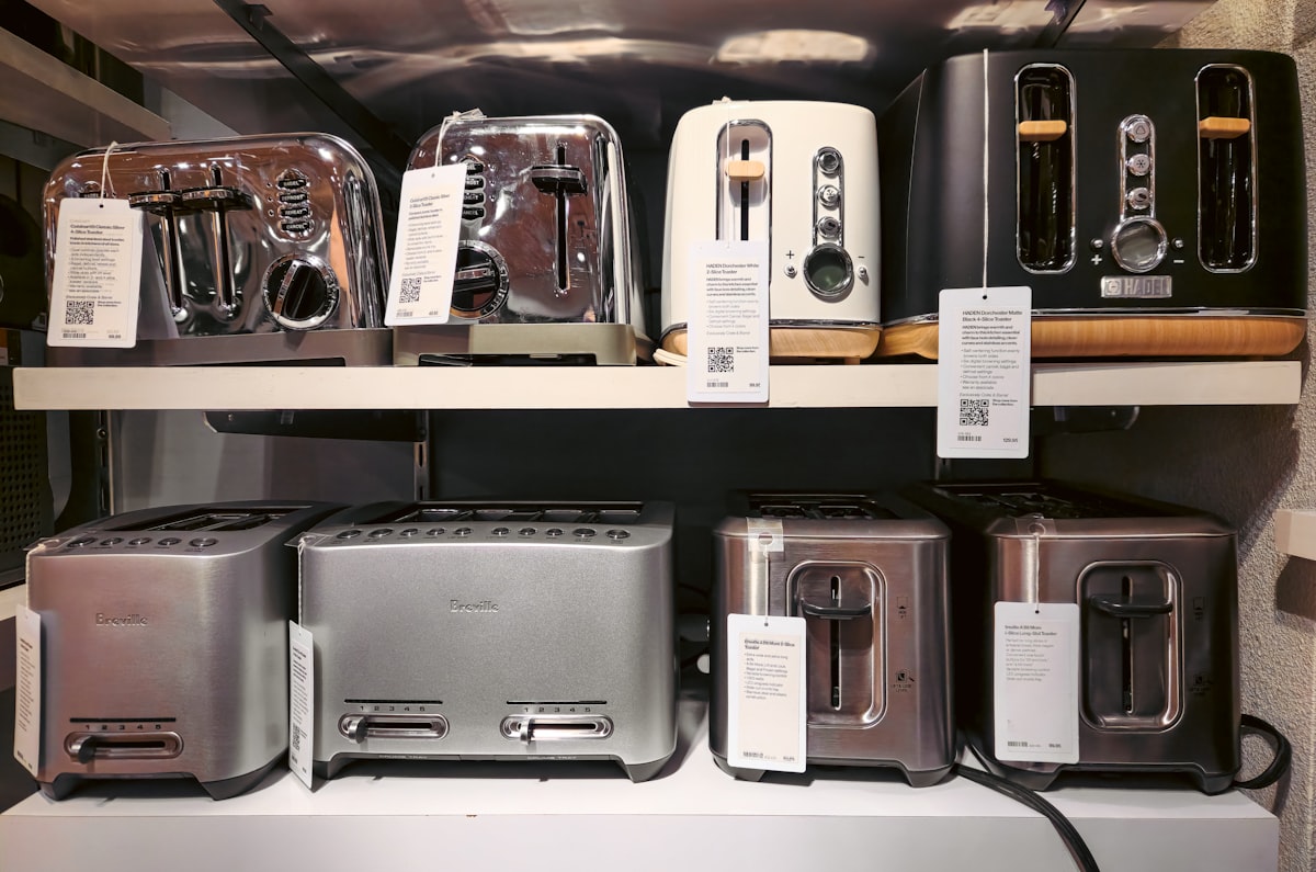 This image showcases shelves filled with toasters in a retail store, displaying a variety of models, sizes, and designs. Toasters are a staple kitchen appliance, commonly used for making breakfast by quickly browning bread slices. related to Sizzling Deals: Navigating Bed Bath and Beyond Toasters
