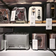 This image showcases shelves filled with toasters in a retail store, displaying a variety of models, sizes, and designs. Toasters are a staple kitchen appliance, commonly used for making breakfast by quickly browning bread slices. related to Sizzling Deals: Navigating Bed Bath and Beyond Toasters