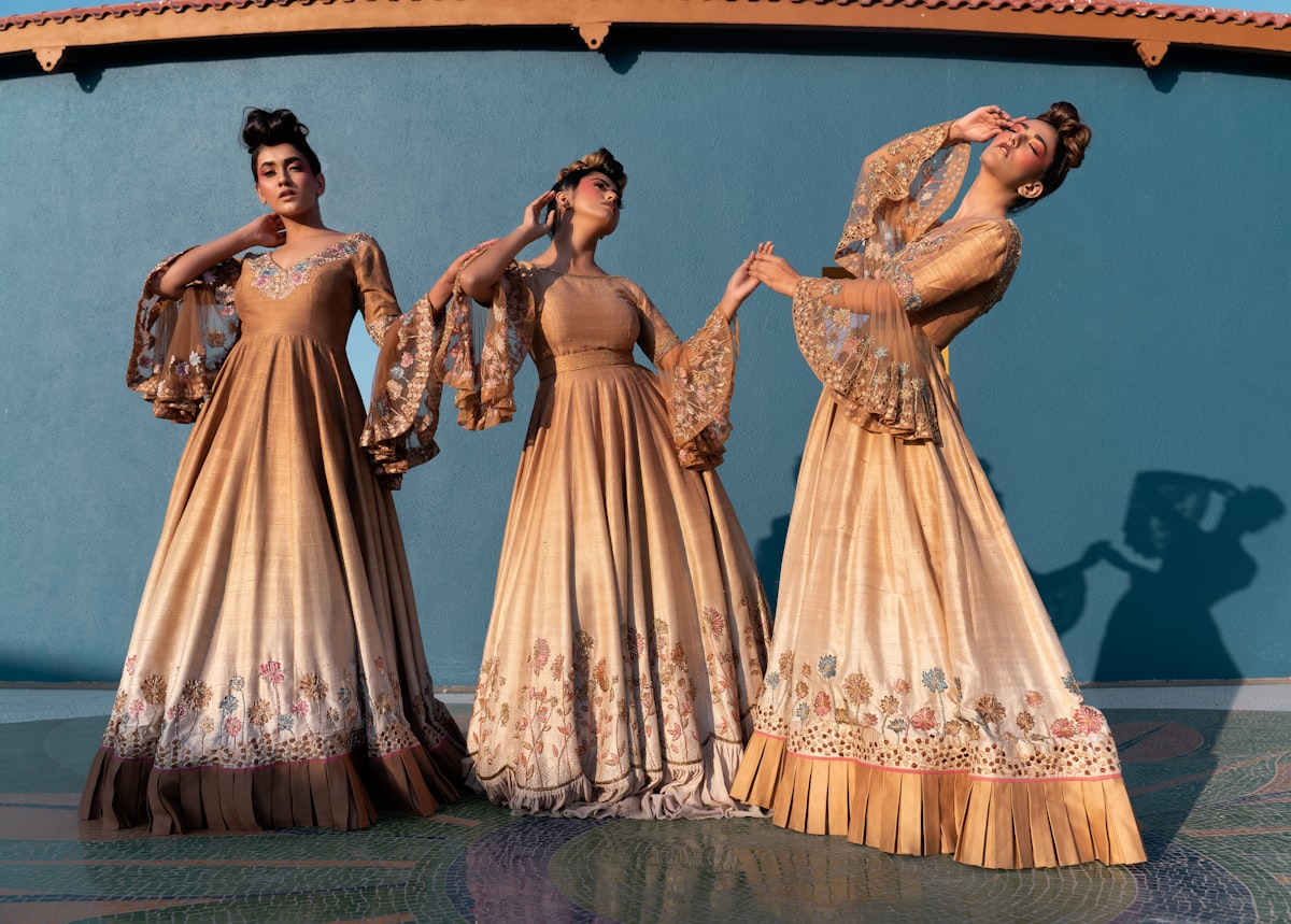 Three women in elegant gold gowns posing together related to Discover the Elegance of Martha Stewart Bedding Collection