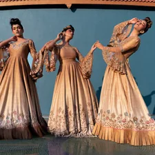 Three women in elegant gold gowns posing together related to Discover the Elegance of Martha Stewart Bedding Collection