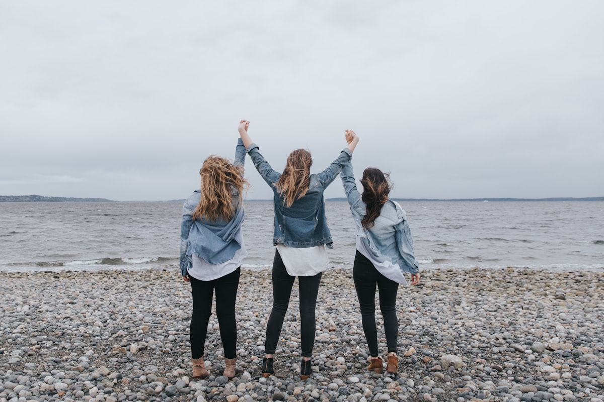 Three women on beach celebrating related to Dreamy Retreats: Tween Girls Bedding Ideas for a Cozy Oasis