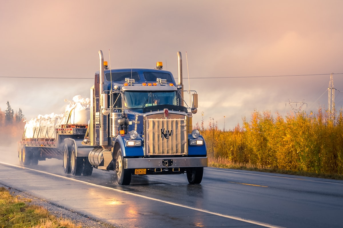 Truck driving on the road related to Maximize Your Truck's Capacity with the Perfect Bed Divider