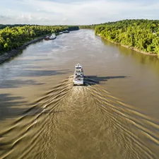 Tug going up the Yazoo River Diversion Canal towards the Port of Vicksburg. related to Charming Retreats on the Mississippi:  Discovering the Magic of Natchez Bed and Breakfasts