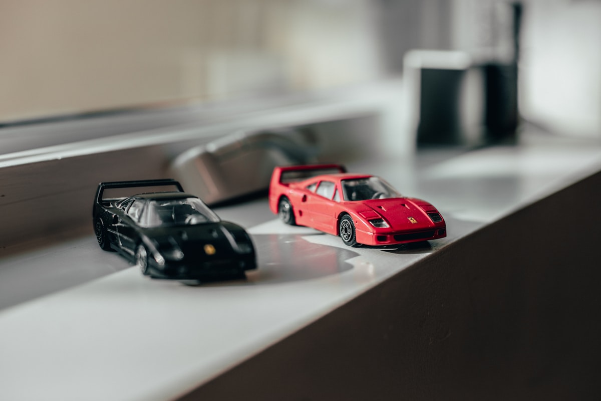 two black and red sprots car toys near windwo related to Start Your Engines: Ultimate Guide to Race Car Beds for Boys