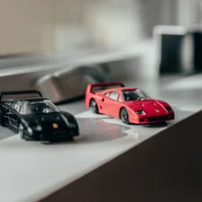 two black and red sprots car toys near windwo related to Start Your Engines: Ultimate Guide to Race Car Beds for Boys