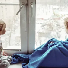 two children sitting near the window and communicate with each other related to Top Tips for Choosing the Perfect Kids Window Valance
