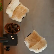 Two fluffy chairs and a basket of wood. related to Cozy Comfort for Little Potters: Discover Pottery Barn Kids Bedding