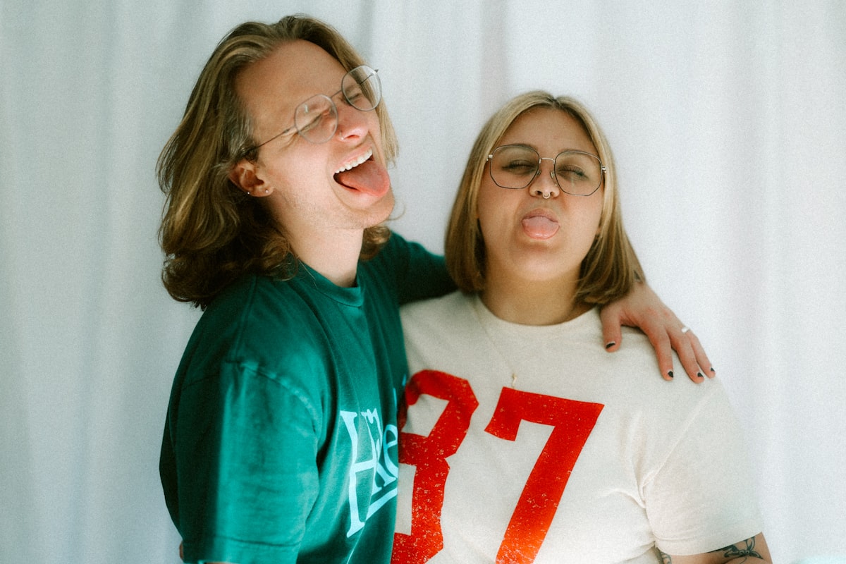 Two people are sticking their tongues out. related to The Ultimate Guide to Twin Size Bed Dimensions