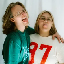 Two people are sticking their tongues out. related to The Ultimate Guide to Twin Size Bed Dimensions