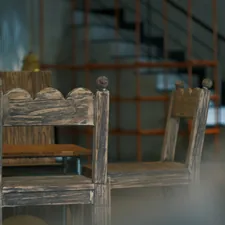 Two rustic wooden chairs in a dimly lit room. related to Elevate Your Home's First Impression with an Entryway Bench with Back