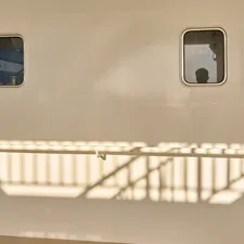 Two windows and a railing are shown on a wall. related to The Ultimate Guide to Choosing the Perfect Train Twin Bed