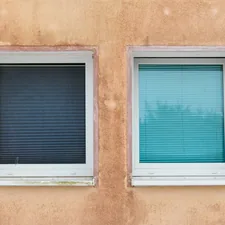 Two windows on a textured wall related to Elevate Your Windows with Unique Valances