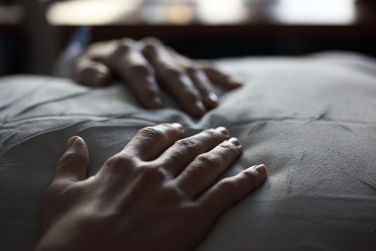 Unedited photo of my wife resting her hands on a pillow. related to Exploring the Dynamics of Being Handcuffed to a Bed