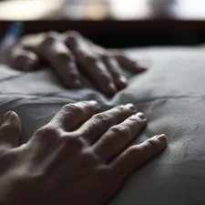Unedited photo of my wife resting her hands on a pillow. related to Exploring the Dynamics of Being Handcuffed to a Bed