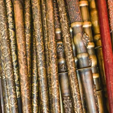 Various wooden flutes displayed at a market in an Asian city during the daytime - Wooden flutes of different shapes and sizes lie side by side at a market. The market is busy with visitors exploring musical instruments and local crafts during the day. related to Brass Beds for Sale: Timeless Elegance for Your Bedroom