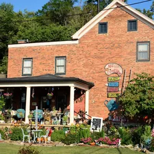 Very busy porch with flowers and misc. related to Discover the Charm of WV Bed and Breakfast Getaways