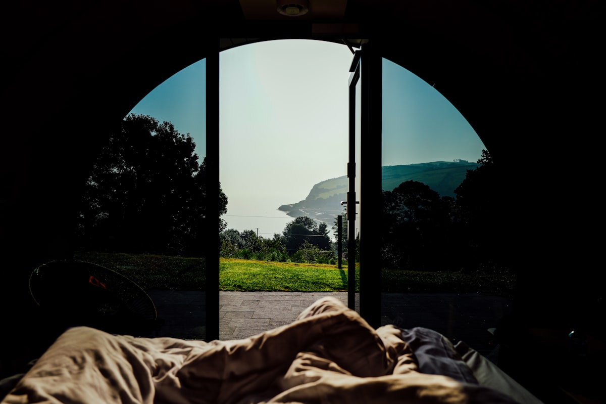 View from tent into a landscape with ocean. related to Elevate Your Camping Experience with Double Camping Beds
