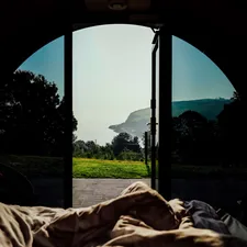View from tent into a landscape with ocean. related to Elevate Your Camping Experience with Double Camping Beds