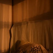 Warm sunlight casts striped shadows on a wall related to Transform Your Bedroom with a Sun and Moon Bed Set