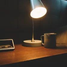 white and black ceramic mug beside white ipad on brown wooden table related to The Perfect Bedtime Companion