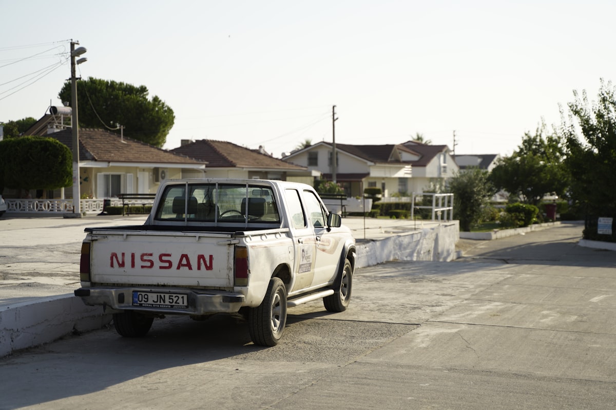 white and black chevrolet crew cab pickup truck parked on gray concrete road during daytime related to Maximizing Utility: The Best Nissan Frontier Bed Racks for Adventure and Work