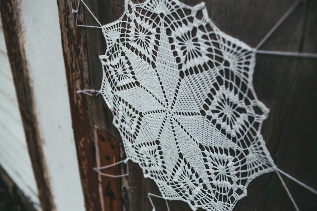 white and black textile on brown wooden surface related to Crochet Valance Pattern