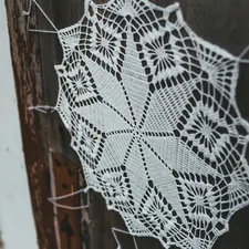 white and black textile on brown wooden surface related to Crochet Valance Pattern