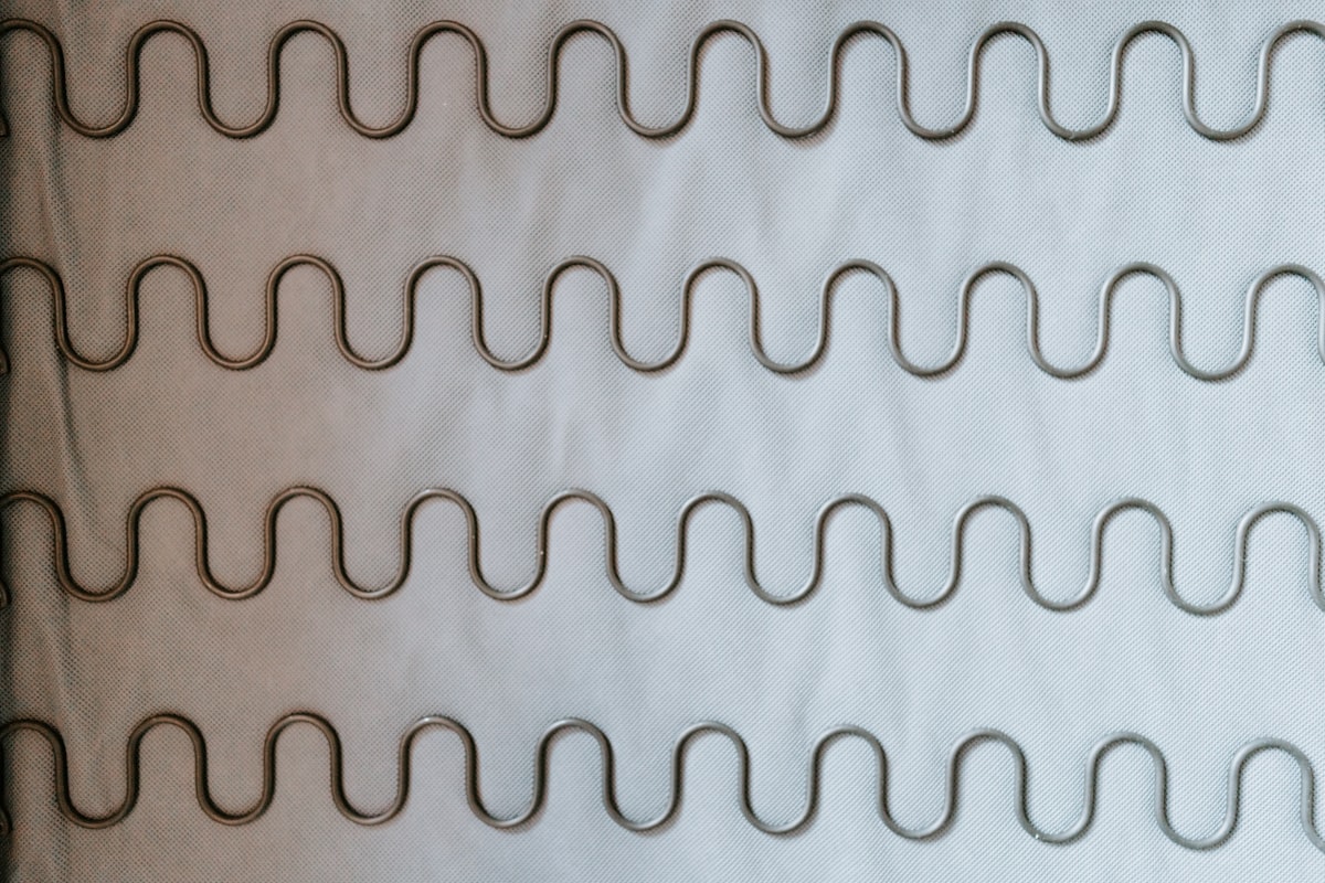 white and brown brick wall related to The Art of Bed Head: Mastering the Effortless Wave