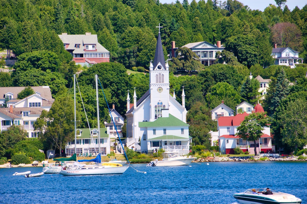 white and brown concrete building near body of water during daytime related to A Paradise Found: Bed and Breakfasts on Mackinac Island