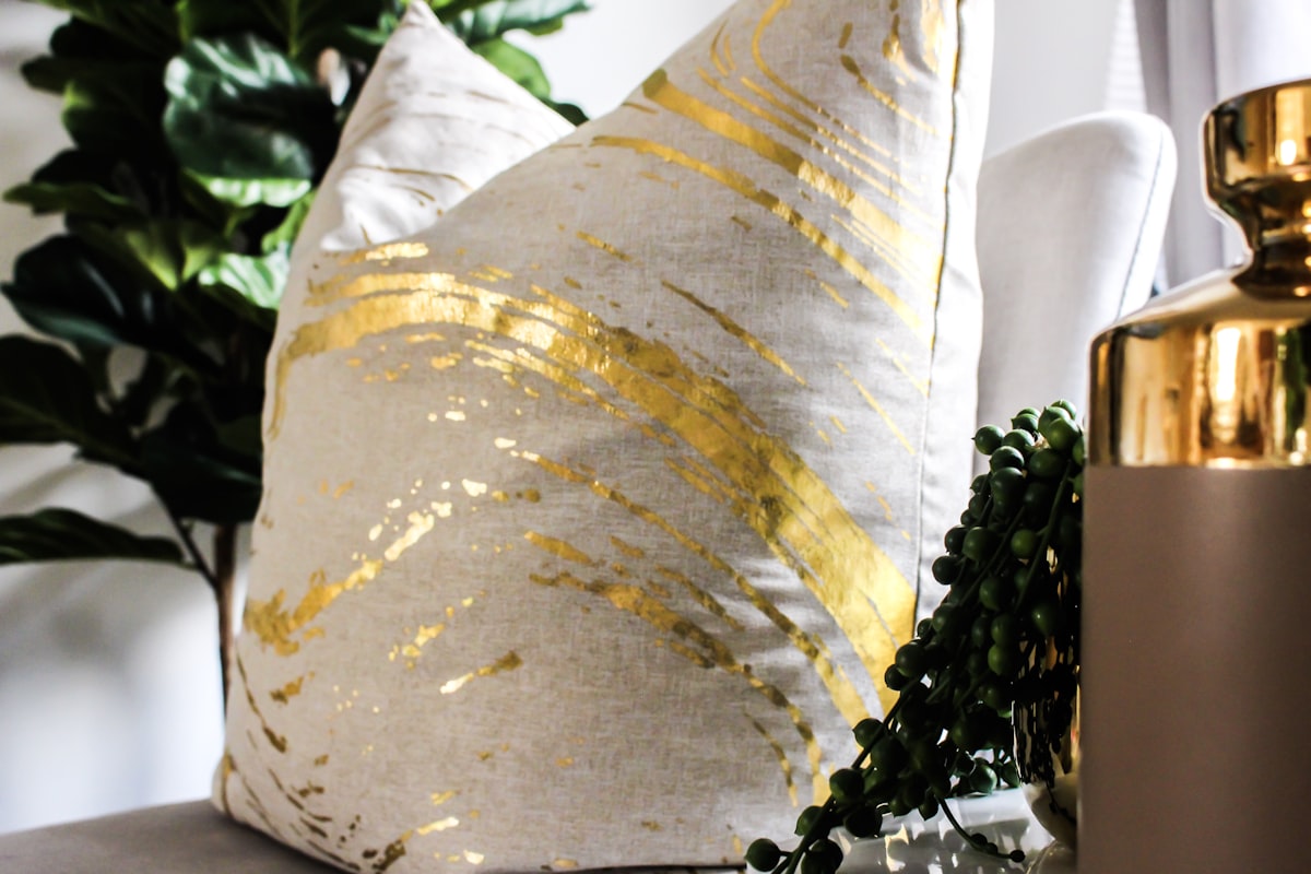 white and brown pillow related to Elevate Your Decor: The Luxe Appeal of Gold Valance Curtains