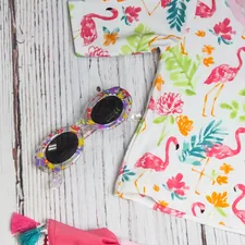 white and multicolored crew-neck shirt near sunglasses related to Transform Your Nursery with Flamingo Crib Bedding