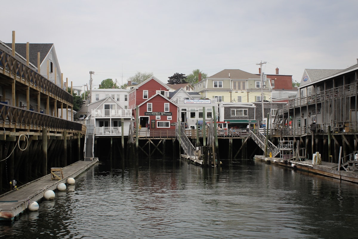 white and red houses beside river during daytime related to Discover the Charm of Portland Maine Bed and Breakfast