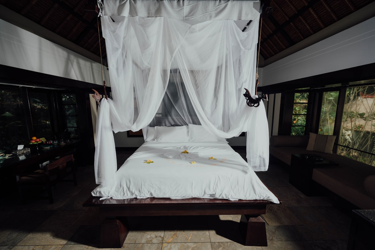 white bed linen on bed related to The Ultimate Guide to Canopy Bed Frames
