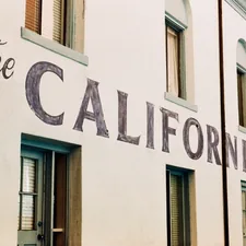 White building with "the california" painted on its side. related to Exploring the Dimensions of a California King Size Bed
